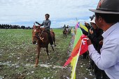 Horse Racing during the Lapste - Tibet China  ; Equestrian Festival Lapste <br>Every year, in june, the villages of a each valley are gathering together for horse races. Monks watching the races.