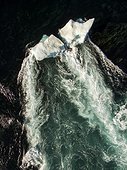 Aerial view of iceberg grounded in shallow rapids during tidal rip in Wager Bay on summer morning, Ukkusiksalik National Park, Nunavut Territory, Canada