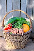 Basket of various autumn vegetables: pumpkin, zucchini, peppers, carrots, country atmosphere,