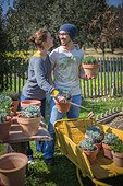 Young couple with aromatic plants in a garden