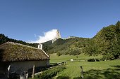 Romanesque chapel with a thatched roof, renovated in 2001 and Mont Aiguille, Hamlet Trézanne , Vercors Regional Natural Park , Saint-Martin-de-Clelles , Rhone- Alpes , France