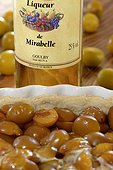 liquor bottle and pie Mirabelle plum (Prunus domestica syriaca), Lorraine, France