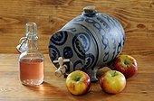 Vinegar pot, apple and cider vinegar on a table Alsace France, former Blue Stoneware Alsacian pot Betschdorf for vinegar