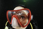 Scuba diver is watching a Craspedacusta sowerbii, freshwater jellyfish, phylum Cnidaria, invasive species. Lugano lake, Ticino, Switzerland