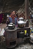 Woman with prayer wheel inside a Yack wool tent, Surroundings of Korzok, Leh, Ladakh, Himalayas, India