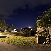 Dolmen of Crucuno, Plouharnel, Brittany, France. The Crucuno Dolmen is surrounded by lampposts. With so much light, it's hard to see anything other than Venus and the coachman's brightest stars.