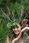 Young woman with crown flowers on her head - living in harmony with nature - reconnecting with nature
