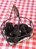 Truffes du Périgord, summer truffle, in a basket on a tablecloth, France