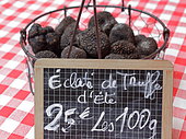 Truffes du Périgord, summer truffle, in a basket on a tablecloth, France