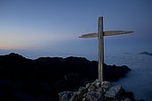 Wooden cross above a sea of ​​fog, Alps, France