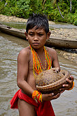 Mentawai boy carrying a pangolin, Siberut, Mentawai, Indonesia