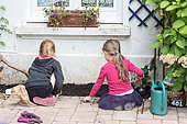 Little girls planting 'scarlet runners' beans