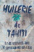 Bag and emblem of the oil mill of Tahiti, unique manufacturer of coconut oil, especially for the manufacture of Monoï de Tahiti AOC, Papeete, French Polynesia