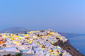 View over the village Fira, administrative capital of the island of Santorini built on the caldera at dusk, Cyclades, Greece.