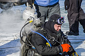 Scuba diver preparing for ice diving, Lake Baikal, Siberia, Russia