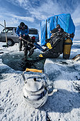 Scuba divers preparing for ice diving, Lake Baikal, Siberia, Russia