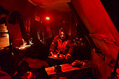Explorers in a small hut in Greenland, February 2016, The red light doesn't dazzle them