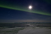 Full moon and aurora borealis over the Scoresbysund, Greenland, February 2016