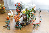 Floral decoration composed of Physalis, Crops honesty, Holly, Cotoneaster