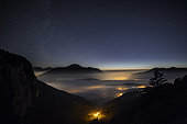 Stratus cloud lit by alpine villages, France