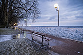 Bench and balustrade frozen in Evian, on the front of Lake Geneva, France