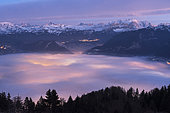 Stratus lit by Cluses in the setting sun and massif of Mont Blanc, Alpes, France