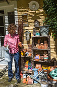 Girl in the middle of different earthen pots in the garden, Provence, France