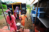 The honey of the untouchables, Irula women load honey containers in front of the Hasanur resource center. Tamil Nadu, India