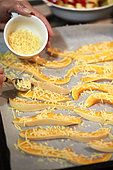 Adding cheese to butternut slices