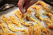 Adding herbs to butternut slices