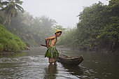Woman fishing with landing net, Pulau Siberut, Sumatra, Indonesia