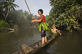 Women going to fish on their dugout, Pulau Siberut, Sumatra, Indonesia