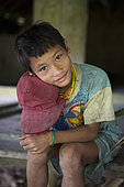 Boy at the Sekolah Patas, an unofficial, non-governmental school, Pulau Siberut, Sumatra, Indonesia