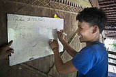 Mathematics exercise at the Sekolah Patas,an unofficial, non-governmental school, Pulau Siberut, Sumatra, Indonesia