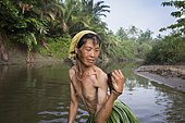 Woman fishing with a landing net, Pulau Siberut, Sumatra, Indonesia