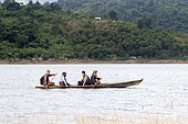 Boat on the water with 4 people on board, Doyang Hydroelectric Dam, where up to one million birds : Amur falcon (Falco amurensis) concentrate on the road to their migration to southern Africa, Nagaland, India