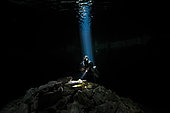 Scuba diver in a blue ray of light, Yucatan Peninsula, Mexico