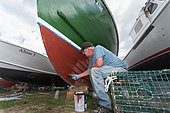 Working on lobster boats in the Spring. Chebeague Island, Casco Bay, Maine