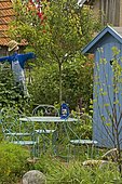 Garden furniture: table, chair. Scarecrow. Mainly blue garden. France