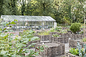Greenhouse and square foot gardens with hazel wood weave