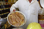 Merchant showing his honey, Taif souq, Saudi Arabia