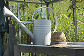 Interior of a garden greenhouse with potting table and gardener equipment, summer, Moselle, France