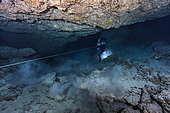 Diver marking an underwater cave, Mayotte, Indian Ocean