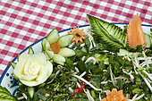 Food carving, making flowers from fruit and vegetables for salad