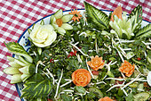 Food carving, making flowers from fruit and vegetables for salad