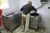 Artisan cleaning his organic poultry slaughterhouse, Provence, France