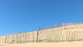 Lattice fence on the Pilat to fix the sand and slow the advance dune. The dune is in perpetual evolution and threatens the constructions and the surrounding forest (dune erosion), Pyla-sur-Mer, Aquitaine, France