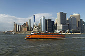 South Manhattan seen from the Hudson River with the ferry connecting Manhattan to Staten Island, New York, USA