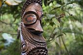 Carved wood in a garden, Efate Island, Vanuatu.
