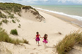 Little girls running in the dunes of the Opal Coast, summer, Pas de Calais, France